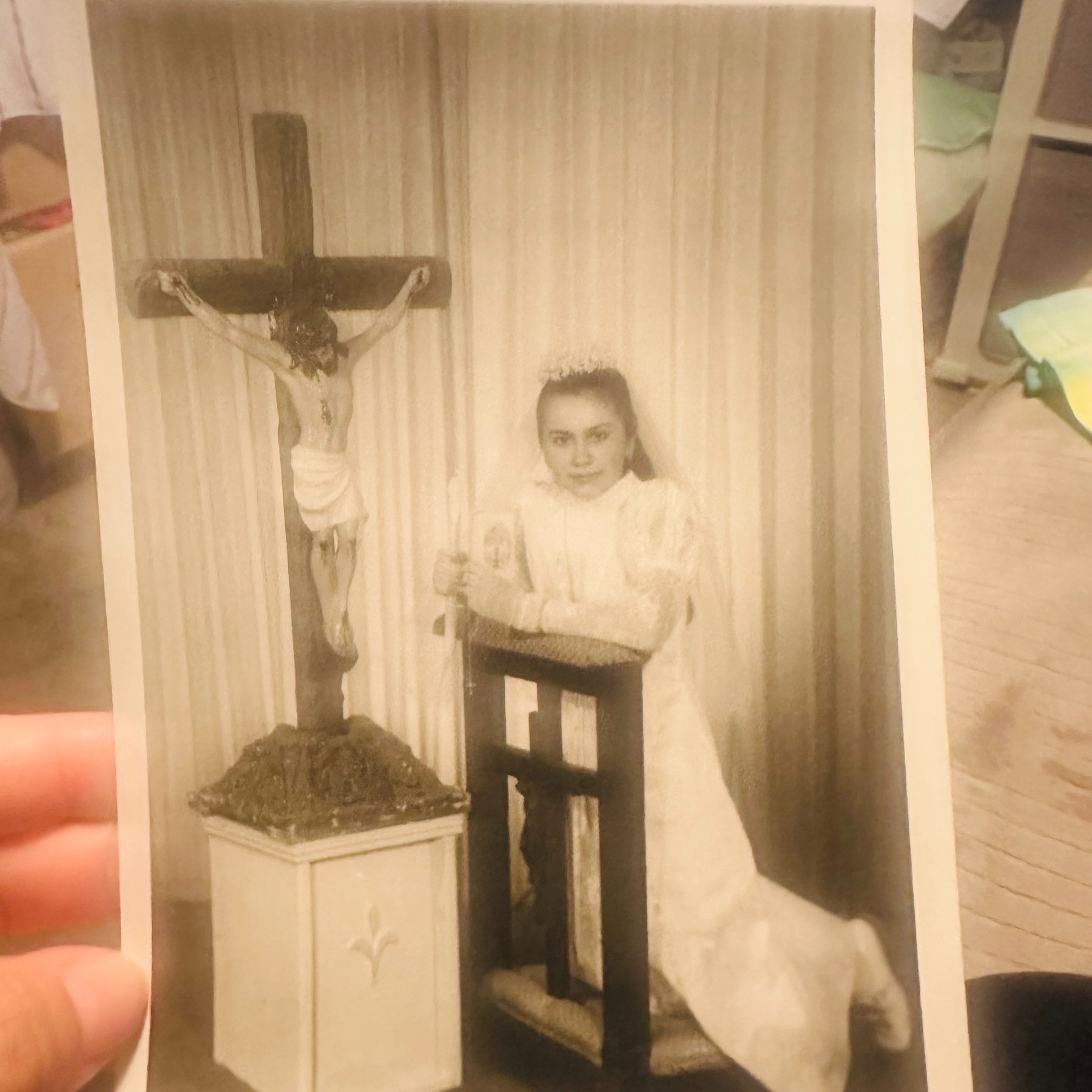 A childhood photograph of Rosalia standing beside a crucifix