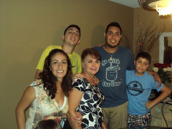 Rosalia standing with her children in a family photograph