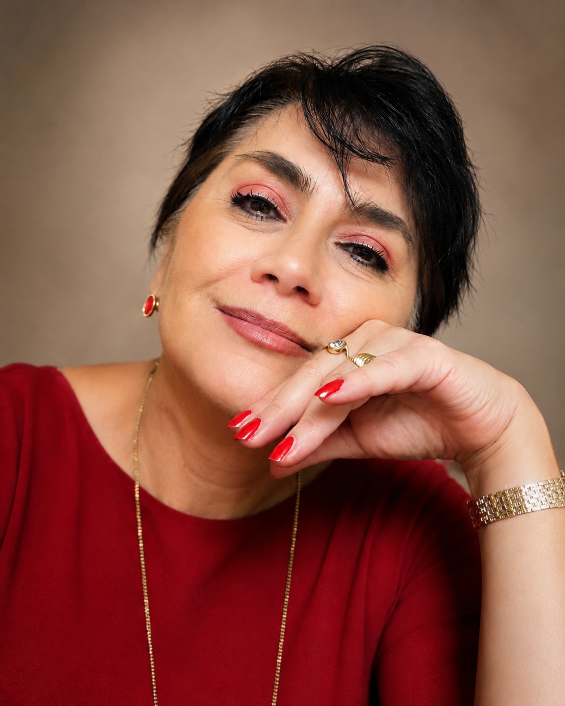 Portrait of Rosalia “Chalia” Gonzalez Arenas wearing a vibrant red top and gold jewelry
